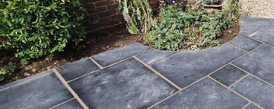 garden pathway with black slate tiles and greenery